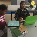 Kids working together in teams to solve the challenge 