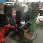 Kids working together in teams to solve the challenge 